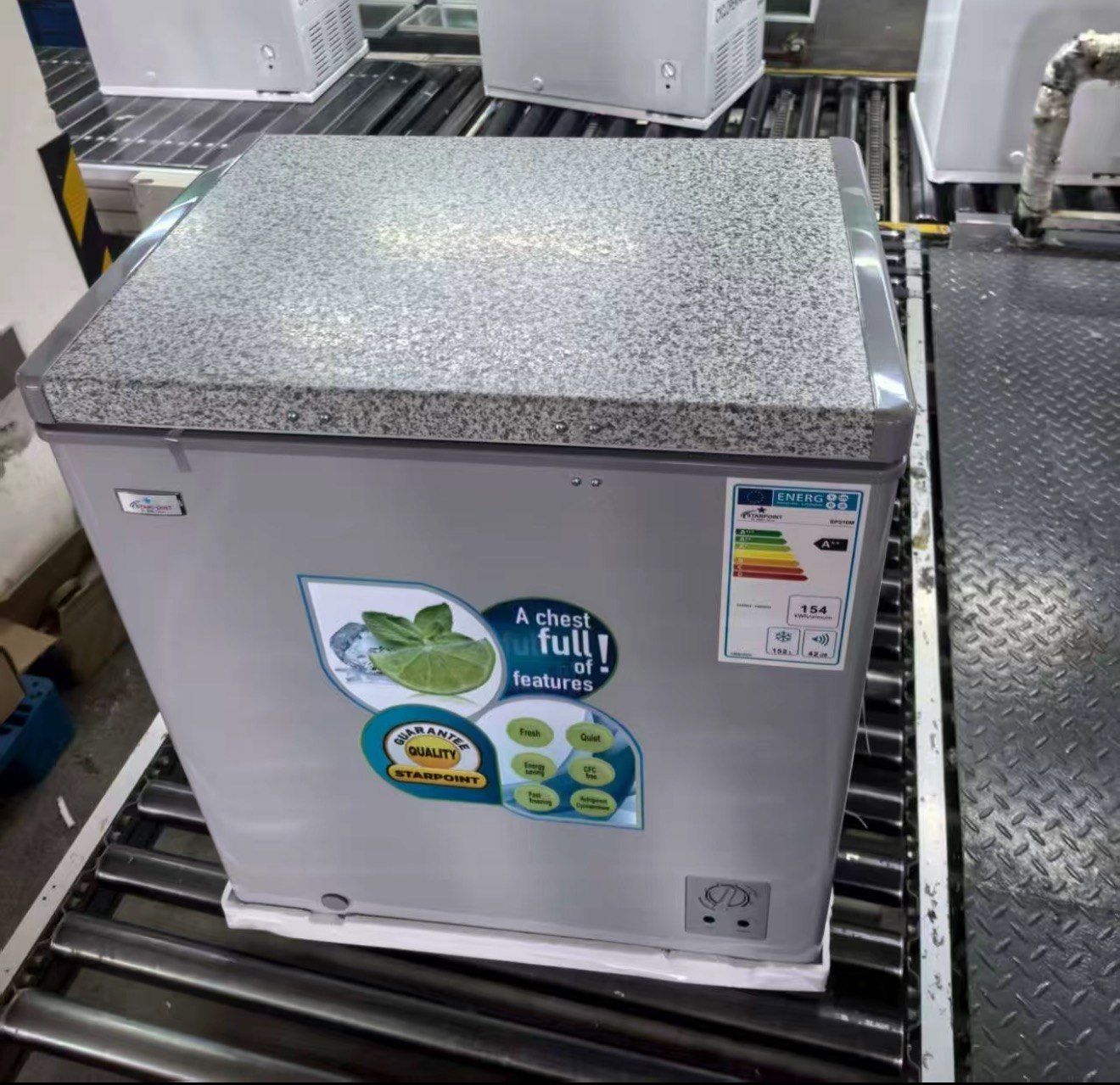 Chest freezer with granite pattern top panel on customer assembly line