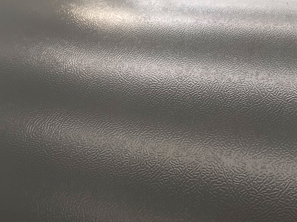 Appliance-grade orange-peel prepainted surface close-up